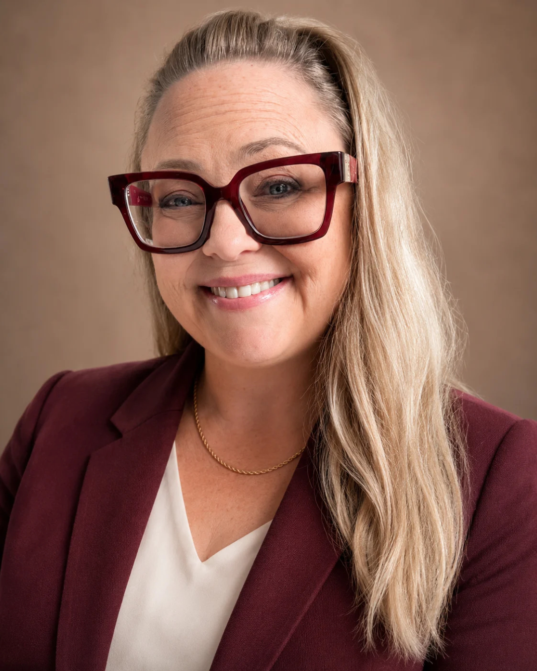 Gina Dunn, founder and brand strategist at OG Solutions in Almere, Netherlands, smiling in a professional headshot